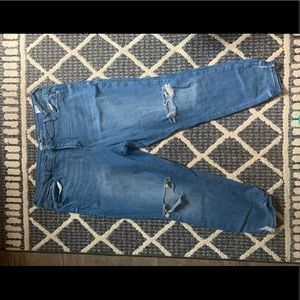 Mid-wash skinny jeans with distress and holes